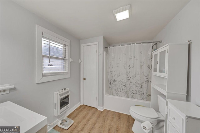 full bathroom with shower / tub combo, toilet, heating unit, and wood finished floors