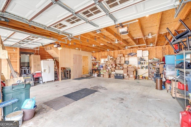 garage with white fridge with ice dispenser and a garage door opener