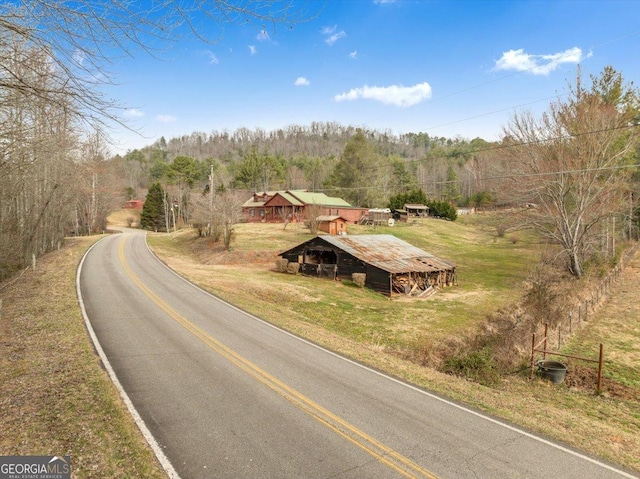 view of street with a forest view