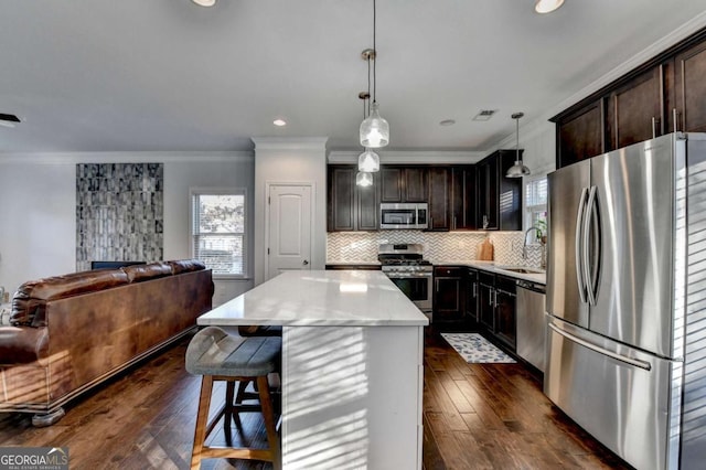 kitchen featuring a center island, backsplash, appliances with stainless steel finishes, open floor plan, and dark brown cabinets