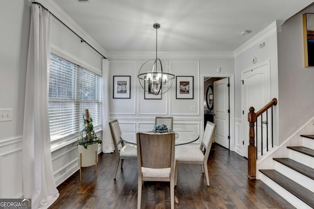 dining area featuring crown molding, dark wood finished floors, a decorative wall, an inviting chandelier, and stairs