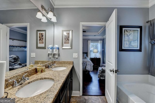 bathroom with a garden tub, crown molding, a sink, and ensuite bathroom