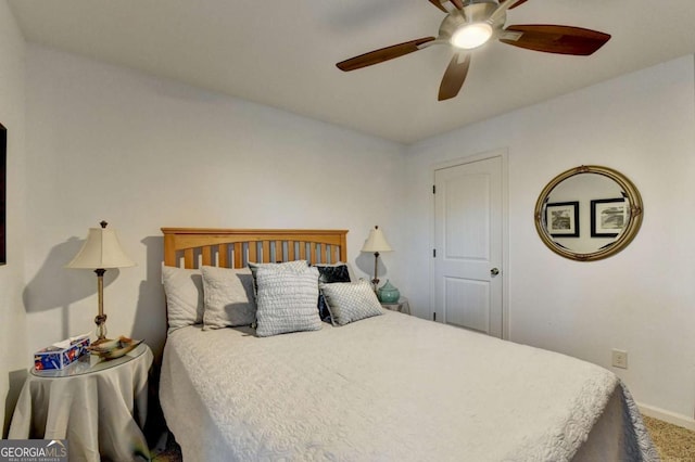 carpeted bedroom featuring baseboards and a ceiling fan