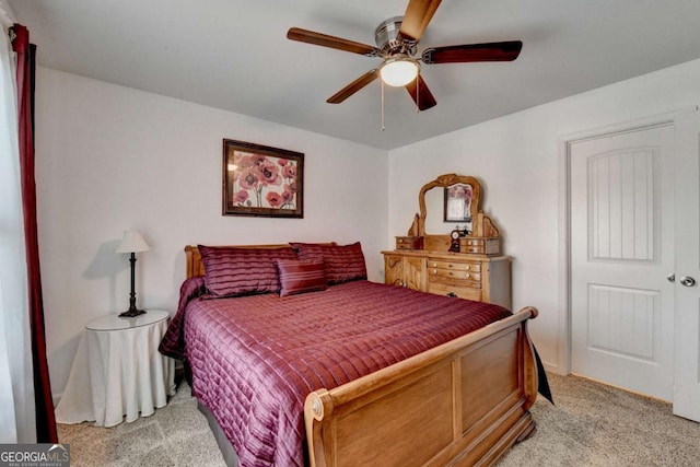 bedroom with ceiling fan and light colored carpet