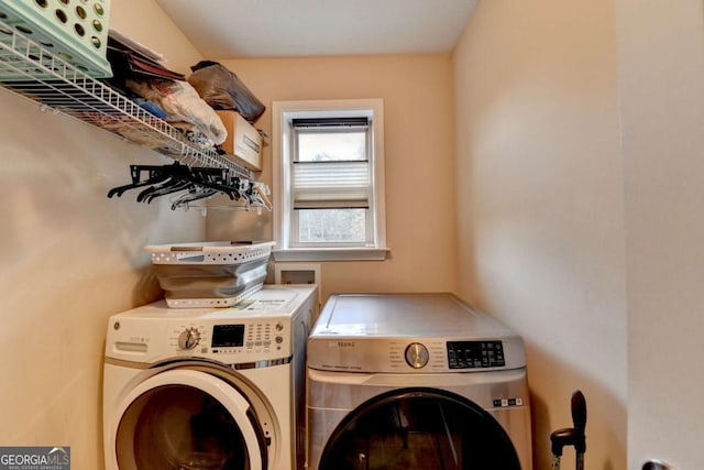 washroom featuring laundry area and washer and clothes dryer