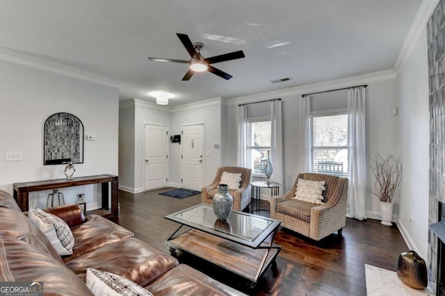 living room with visible vents, ornamental molding, hardwood / wood-style floors, and baseboards