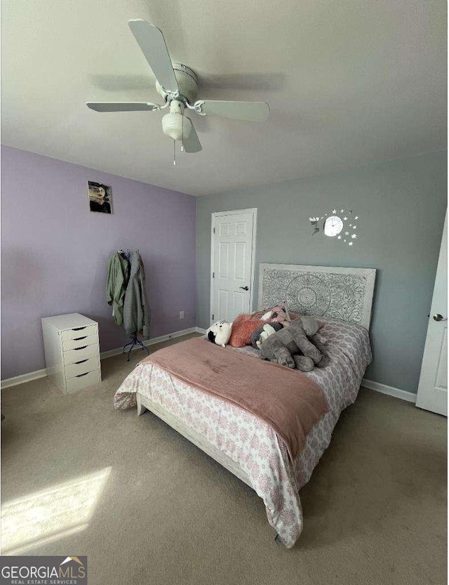 bedroom with a ceiling fan, carpet, and baseboards