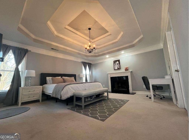 carpeted bedroom with visible vents, ornamental molding, an inviting chandelier, a tray ceiling, and a fireplace