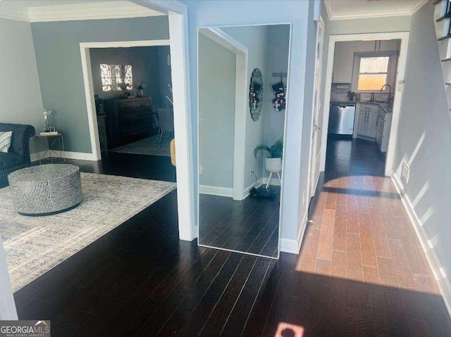 corridor with dark wood-style floors, baseboards, and crown molding