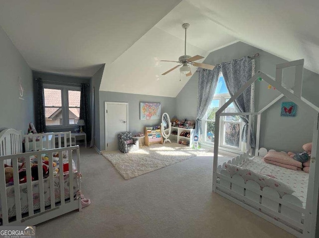 bedroom featuring multiple windows, vaulted ceiling, and carpet flooring