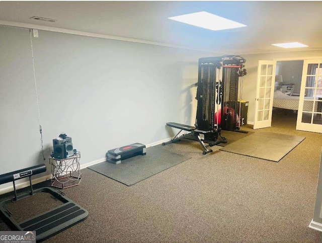 exercise room featuring french doors, carpet flooring, visible vents, and baseboards