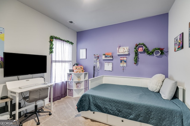 carpeted bedroom featuring visible vents