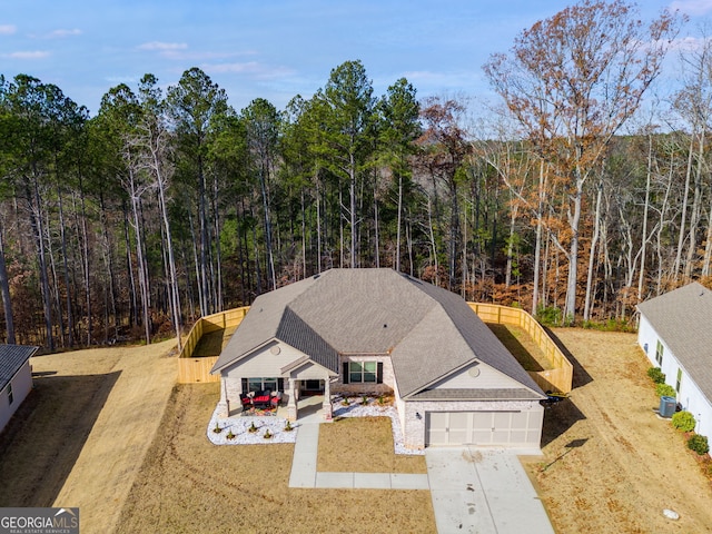 birds eye view of property featuring a view of trees