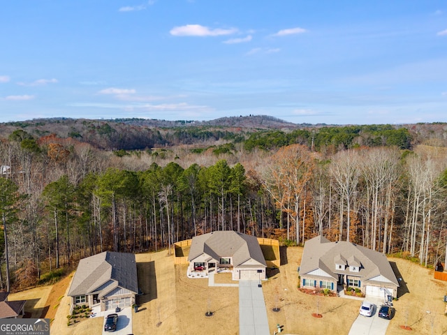 drone / aerial view featuring a forest view