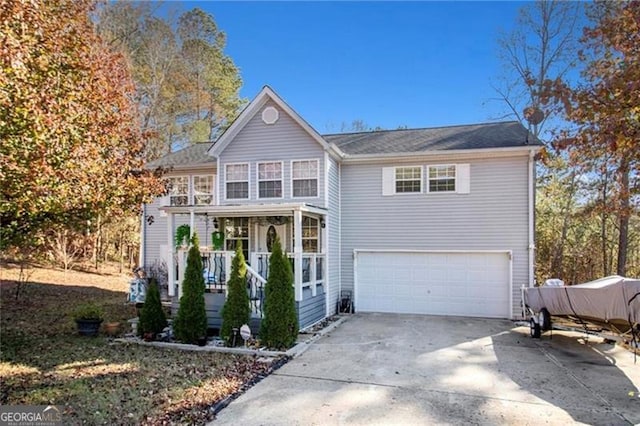 traditional-style home with covered porch, driveway, and an attached garage