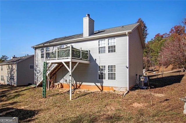 rear view of property with a chimney and a wooden deck