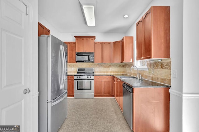 kitchen with tasteful backsplash, brown cabinetry, appliances with stainless steel finishes, light floors, and a sink