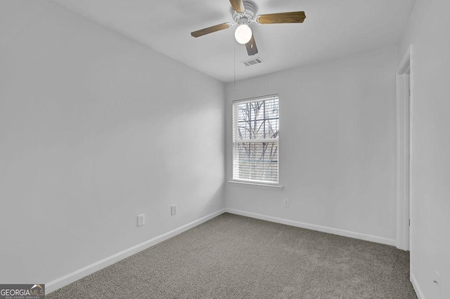 empty room featuring baseboards, ceiling fan, visible vents, and carpet flooring