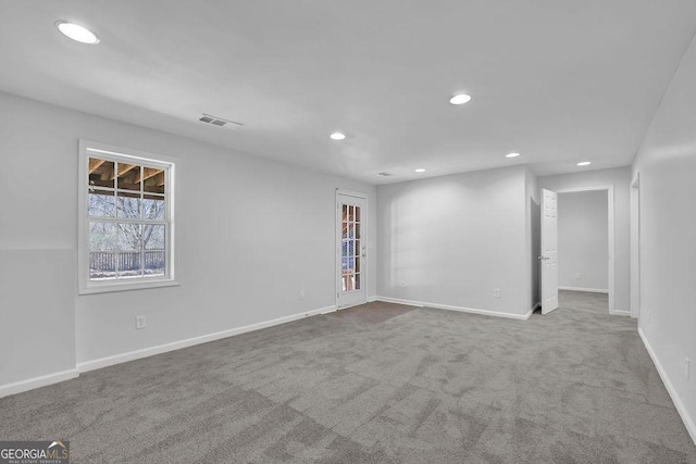 carpeted empty room featuring visible vents, baseboards, and recessed lighting