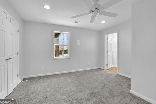 unfurnished bedroom featuring ensuite bath, carpet, baseboards, and recessed lighting