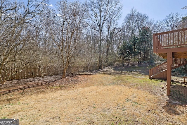 view of yard with a deck and stairway