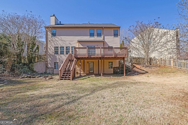 back of house featuring fence, stairs, a lawn, a wooden deck, and a chimney