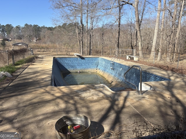 view of pool featuring a diving board, a patio area, fence, and a fenced in pool