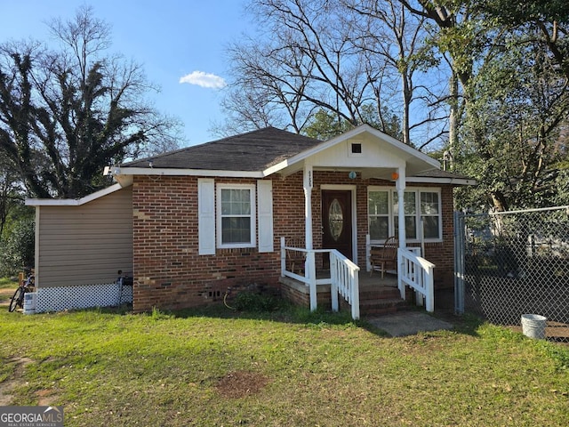 bungalow featuring a front yard, a porch, and brick siding