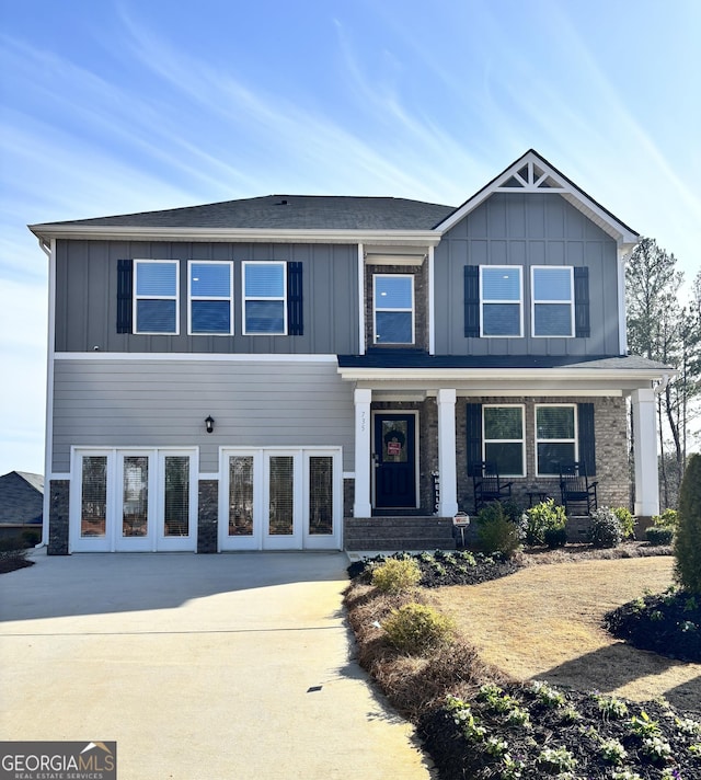 craftsman-style home featuring board and batten siding and stone siding