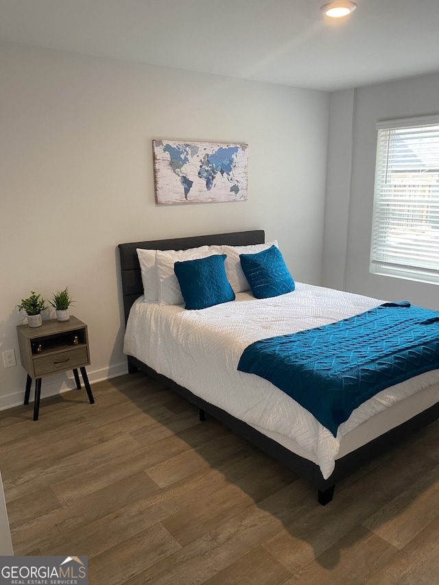 bedroom featuring recessed lighting, baseboards, and wood finished floors