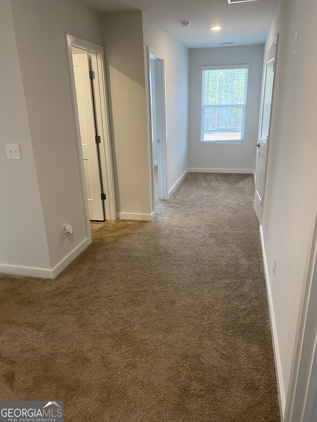 interior space with carpet and baseboards