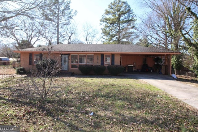 single story home with an attached carport, brick siding, driveway, and a front lawn