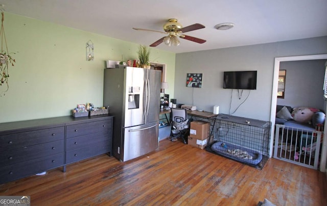 kitchen featuring ceiling fan, stainless steel refrigerator with ice dispenser, and wood finished floors