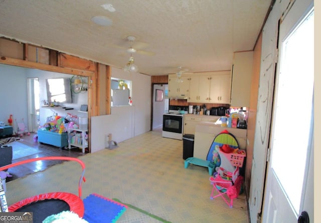 rec room with plenty of natural light and a ceiling fan