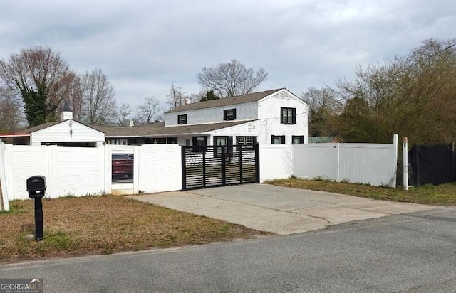 8875 E Broad St, Sparta, GA 31087 - view of front of home with a gate, a fenced front yard, and concrete driveway