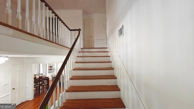 stairs featuring wood finished floors