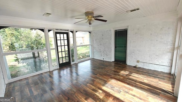 interior space with ceiling fan, brick wall, wood finished floors, and visible vents