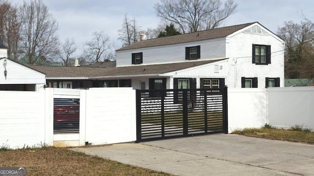 view of gate with a fenced front yard