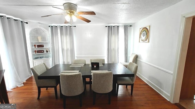 dining area featuring ceiling fan, a textured ceiling, and wood finished floors