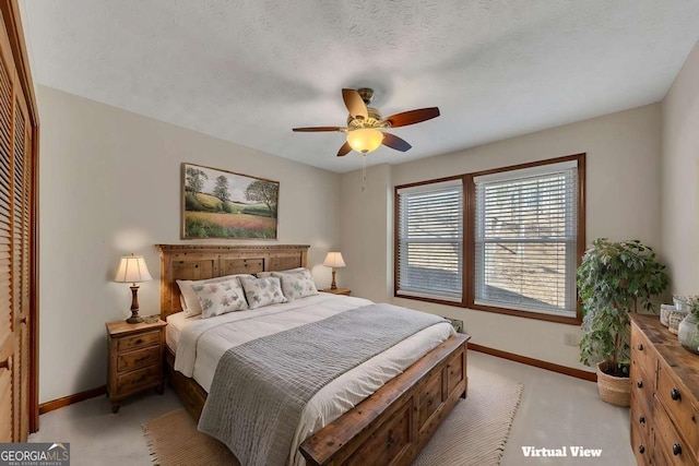 bedroom featuring a closet, ceiling fan, a textured ceiling, and baseboards