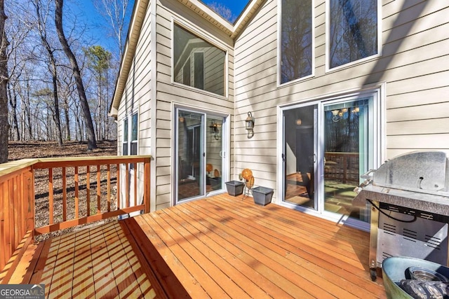 wooden deck with a grill