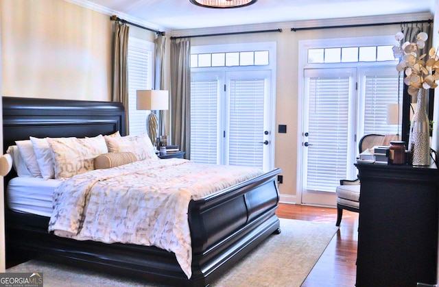 bedroom featuring baseboards and wood finished floors