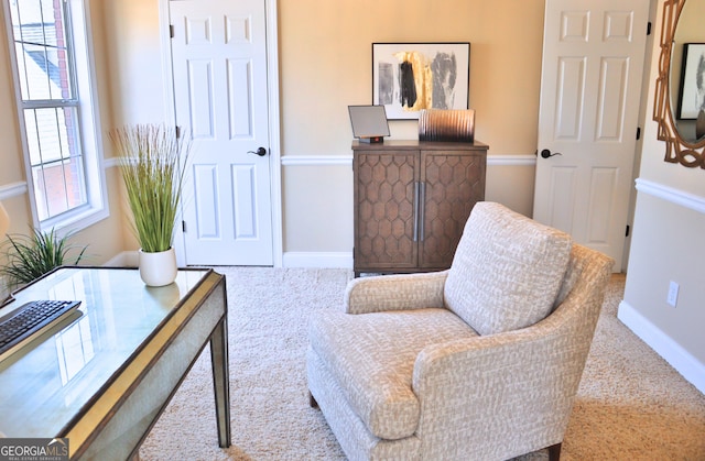 sitting room with carpet flooring and baseboards