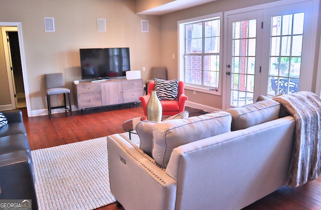 living room featuring wood finished floors, visible vents, and baseboards