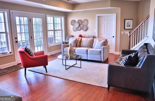 living room with baseboards, stairway, and wood finished floors