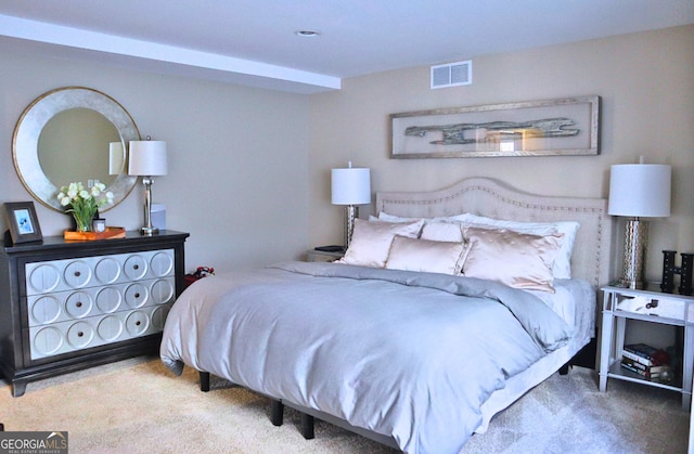 carpeted bedroom featuring visible vents