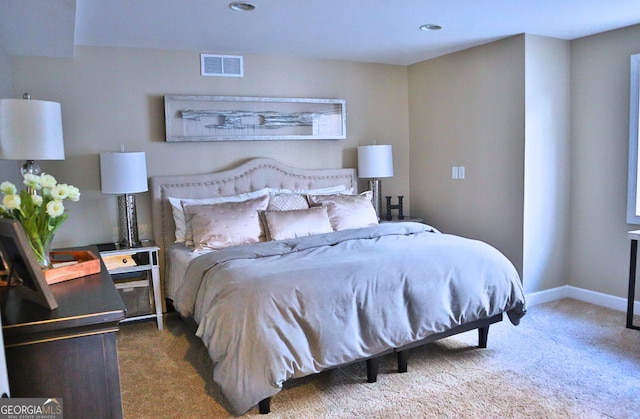 carpeted bedroom with visible vents and baseboards