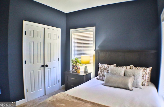 bedroom with carpet floors, a closet, and baseboards