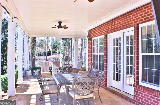 view of patio / terrace featuring outdoor dining space, ceiling fan, and french doors