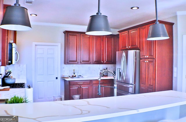 kitchen with crown molding, dark brown cabinets, stainless steel fridge with ice dispenser, and white microwave